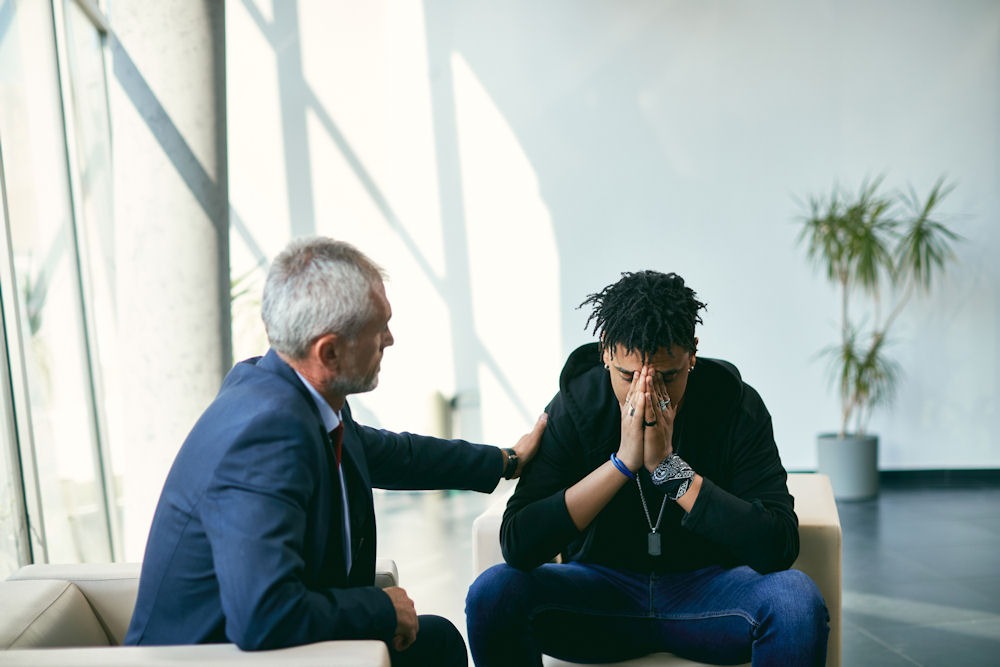 Therapist supporting man struggling with codeine addiction